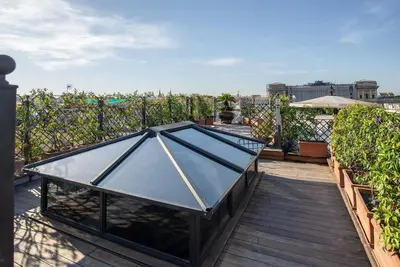 a glass table on the roof of a house at Hotel Isa in Rome