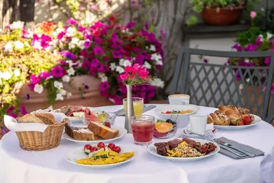 a white table with plates of food on it at Hotel Isa in Rome