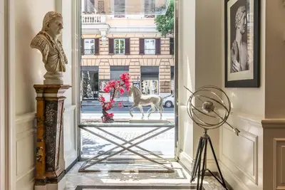 a statue of a horse walking through a glass door at Hotel Isa in Rome