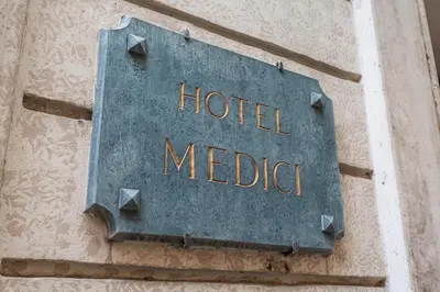 a metal sign on the side of a building at Hotel Medici in Rome
