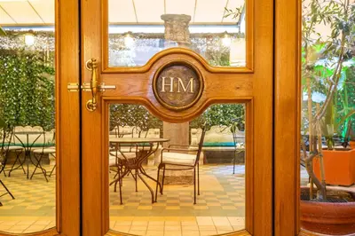 a glass door with a sign that reads hrm at Hotel Medici in Rome