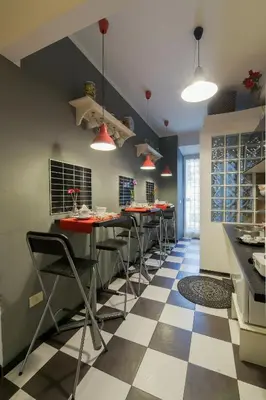 a kitchen with a checkered floor at Barbara Vaticano Affitti Brevi in Rome