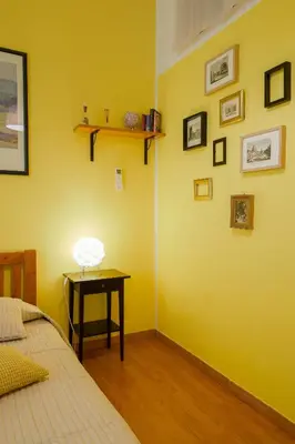 a bedroom with a bed and a table with a lamp at Barbara Vaticano Affitti Brevi in Rome