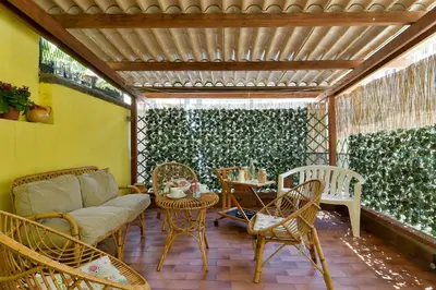 a patio with a couch and chairs and a table at Barbara Vaticano Affitti Brevi in Rome
