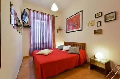 a bedroom with a red bed with a red blanket at Barbara Vaticano Affitti Brevi in Rome