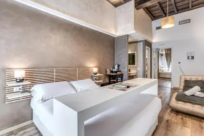 a bedroom with a white bed and a couch at Magenta Pantheon Navona in Rome