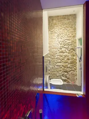 a bathroom with a sink and a stone wall at Magenta Pantheon Navona in Rome