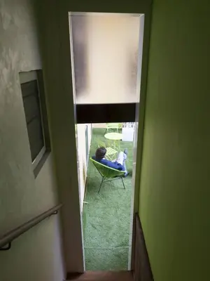 a room with a window and a person sitting in a chair at Magenta Pantheon Navona in Rome