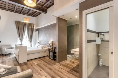 a bedroom with a bed and a bathroom at Magenta Pantheon Navona in Rome