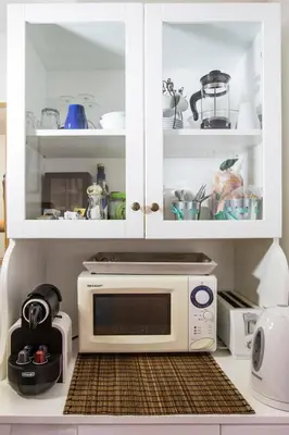 a microwave oven sitting inside of a kitchen cabinets at Pettinary Village B&B in Rome