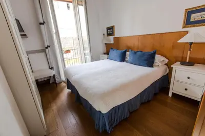 a bedroom with a large bed with blue pillows at Pettinary Village B&B in Rome