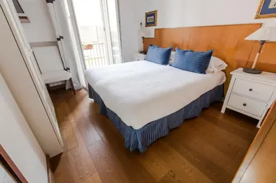 a bedroom with a large bed with blue pillows at Pettinary Village B&B in Rome