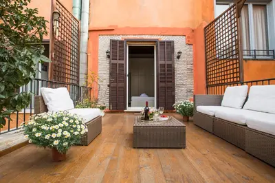 a patio with two couches and a table on a balcony at Pettinary Village B&B in Rome