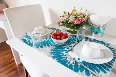 a dining room table with a blue and white table cloth at Pettinary Village B&B in Rome