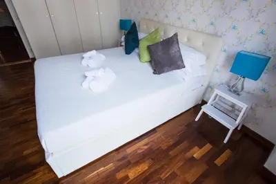 a bedroom with a white bed with stuffed animals on it at Pettinary Village B&B in Rome