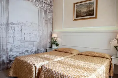a bedroom with a bed and a drawing on the wall at Hotel Palladium Palace in Rome
