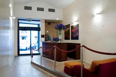 a lobby with a waiting room with a vase of flowers at Hotel Columbia in Rome