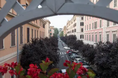 a view of a city street from a window with flowers at Quality Hotel Nova Domus in Rome