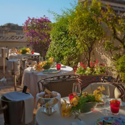 a table with plates of food on top at Hotel Raphaël - Relais & Châteaux in Rome