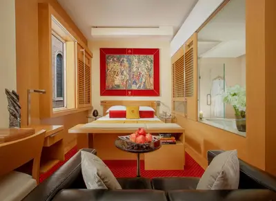 a bedroom with a bed and a table with fruit on it at Hotel Raphaël - Relais & Châteaux in Rome