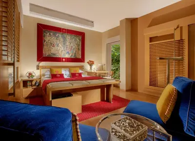 a bedroom with a bed and a painting on the wall at Hotel Raphaël - Relais & Châteaux in Rome
