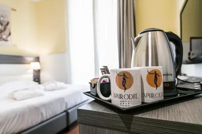 a bedroom with a bed with two towels on it at Hotel Aphrodite in Rome