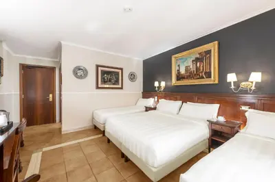 a hotel room with two beds in a room at Hotel Des Artistes Roma in Rome