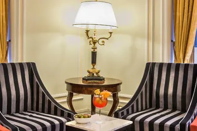 two chairs and a table with a lamp on a table at Albergo del Senato in Rome