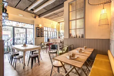 a restaurant with wooden tables and chairs and windows at City Guest House in Rome