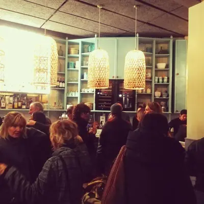 a group of people sitting around a bar with lights at City Guest House in Rome