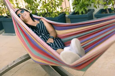 a woman laying in a hammock with a teddy bear at Generator Rome in Rome