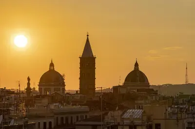 a view of a city with the sun setting at Generator Rome in Rome