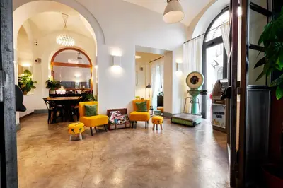 a living room with yellow chairs and a table at Generator Rome in Rome