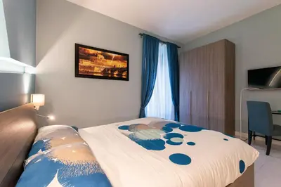 a bedroom with a bed with blue flowers on it at Giulio Cesare Imperatore in Rome