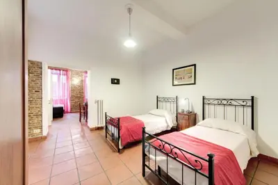 a bedroom with two beds in a room at Nova Domizia in Rome