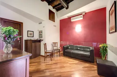 a living room with a couch and a red wall at Nova Domizia in Rome