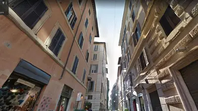 a city street with tall buildings in a city at Nova Domizia in Rome