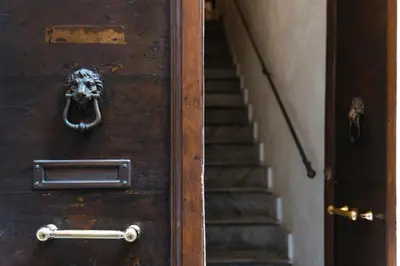 an old wooden door with a skull on it at Dulcis In Pantheon in Rome
