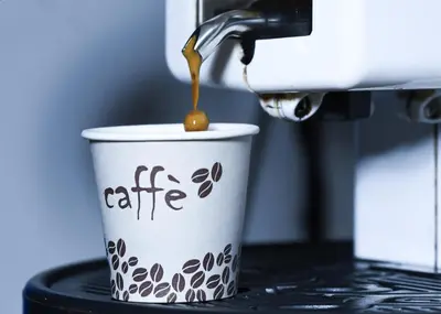 a coffee cup with coffee being poured into it at Dulcis In Pantheon in Rome