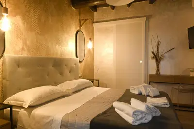 a bedroom with a large bed with towels on it at Dulcis In Pantheon in Rome