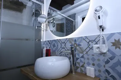 a bathroom with a sink and a mirror at Dulcis In Pantheon in Rome
