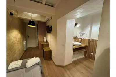 a room with a bathroom with a sink and a bed at Dulcis In Pantheon in Rome