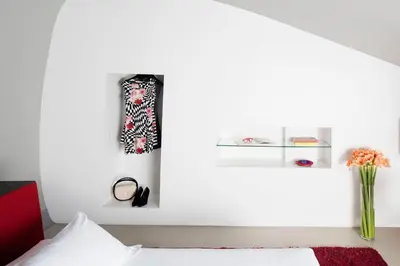 a bedroom with a bed and a vase with flowers at Hotel Ripa Roma in Rome