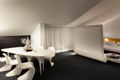 a room with a table and chairs and a bed at Hotel Ripa Roma in Rome