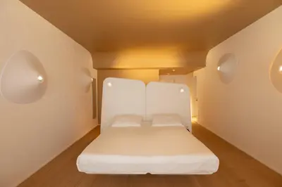 a small bedroom with a white bed in a room at Hotel Ripa Roma in Rome