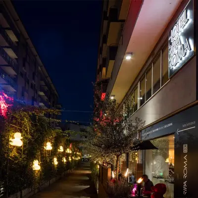 a city street at night with buildings and lights at Hotel Ripa Roma in Rome