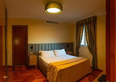 a bedroom with a bed and a window at Hotel Mecenate Palace in Rome