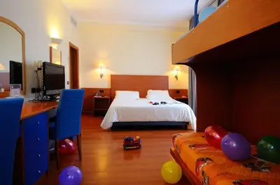 a bedroom with a bed and a blue couch at Best Western Hotel Globus in Rome