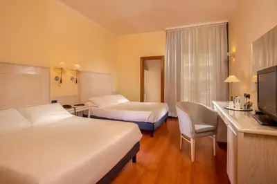 a table topped with plates of food and drinks at Best Western Hotel Globus in Rome