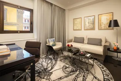 a living room with a couch and a desk at art'otel Rome Piazza Sallustio in Rome